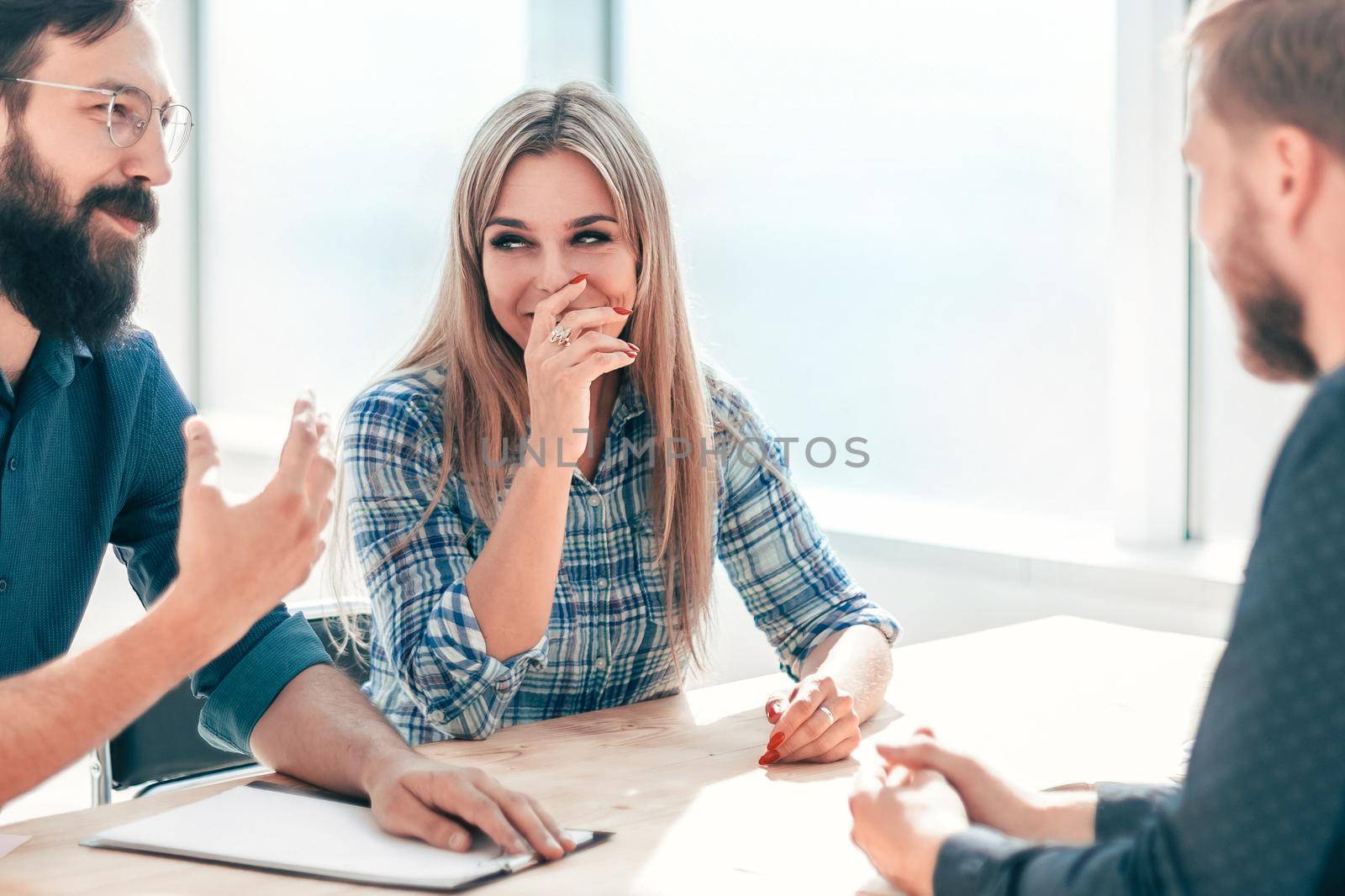 group of successful young people sitting at the negotiating table. the concept of employment
