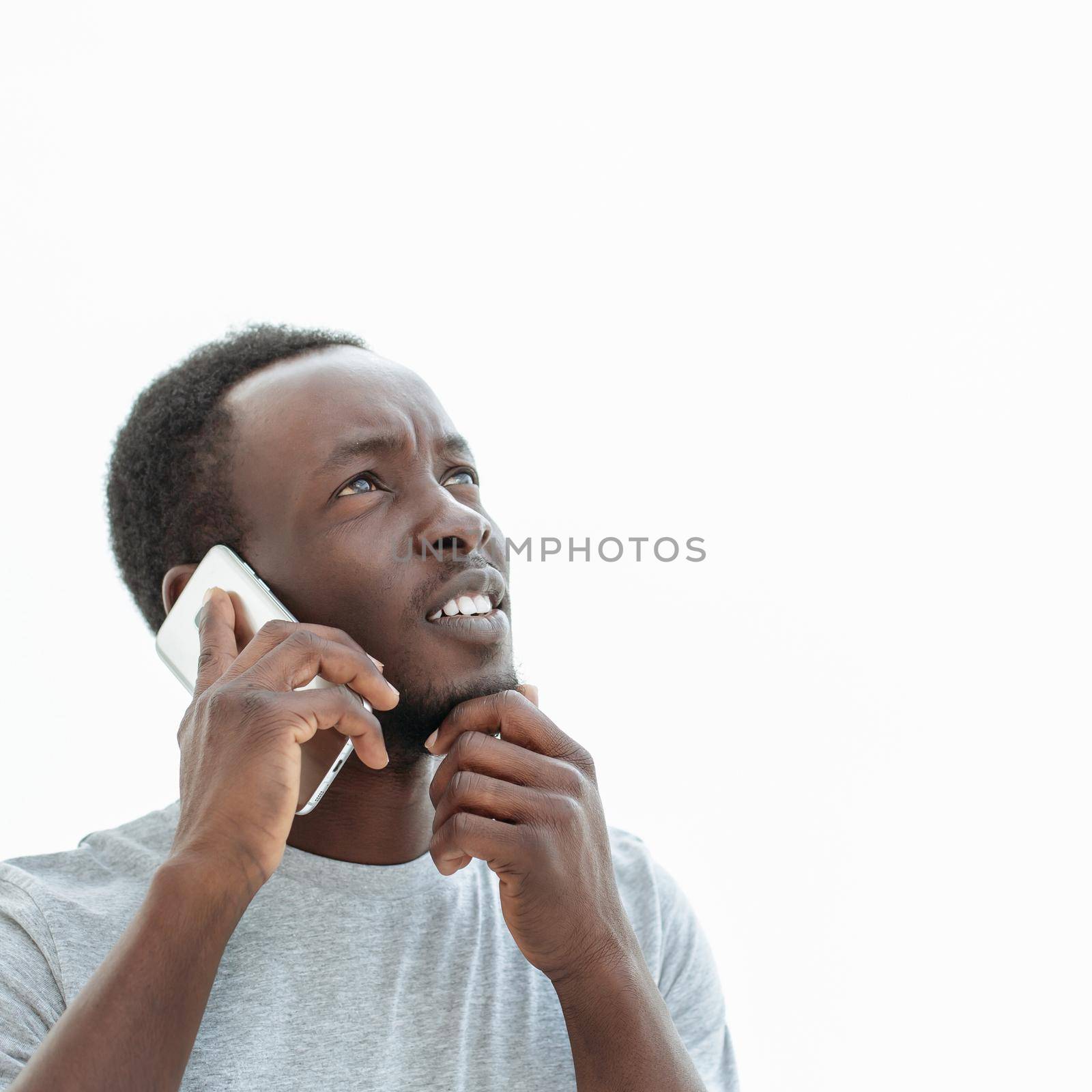 handsome guy with smartphone looking at copy space. isolated on white background