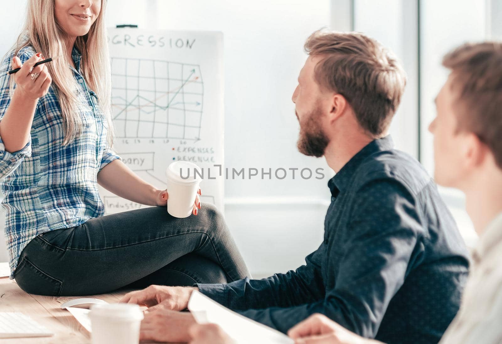 young woman discussing with colleagues new strategy. the concept of teamwork