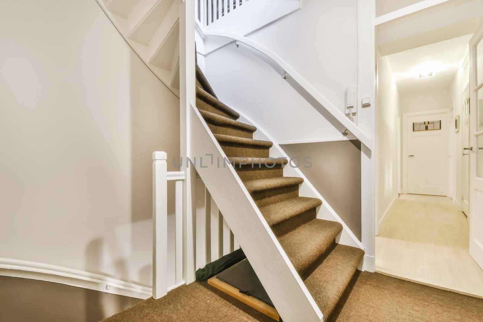 Beautiful staircase with gray carpet and comfortable handrails