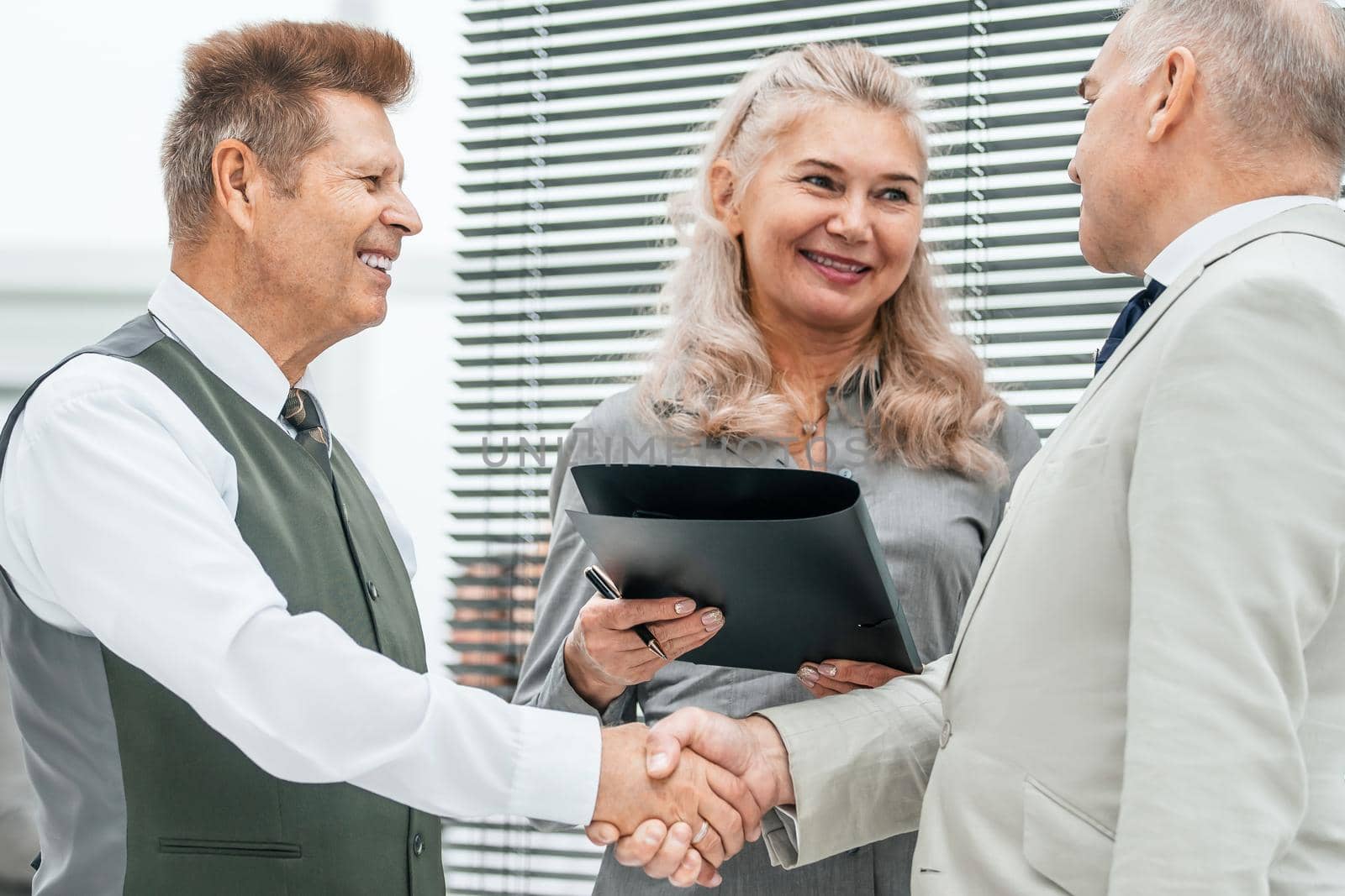 close up. business people confirming the deal with a handshake. office weekdays