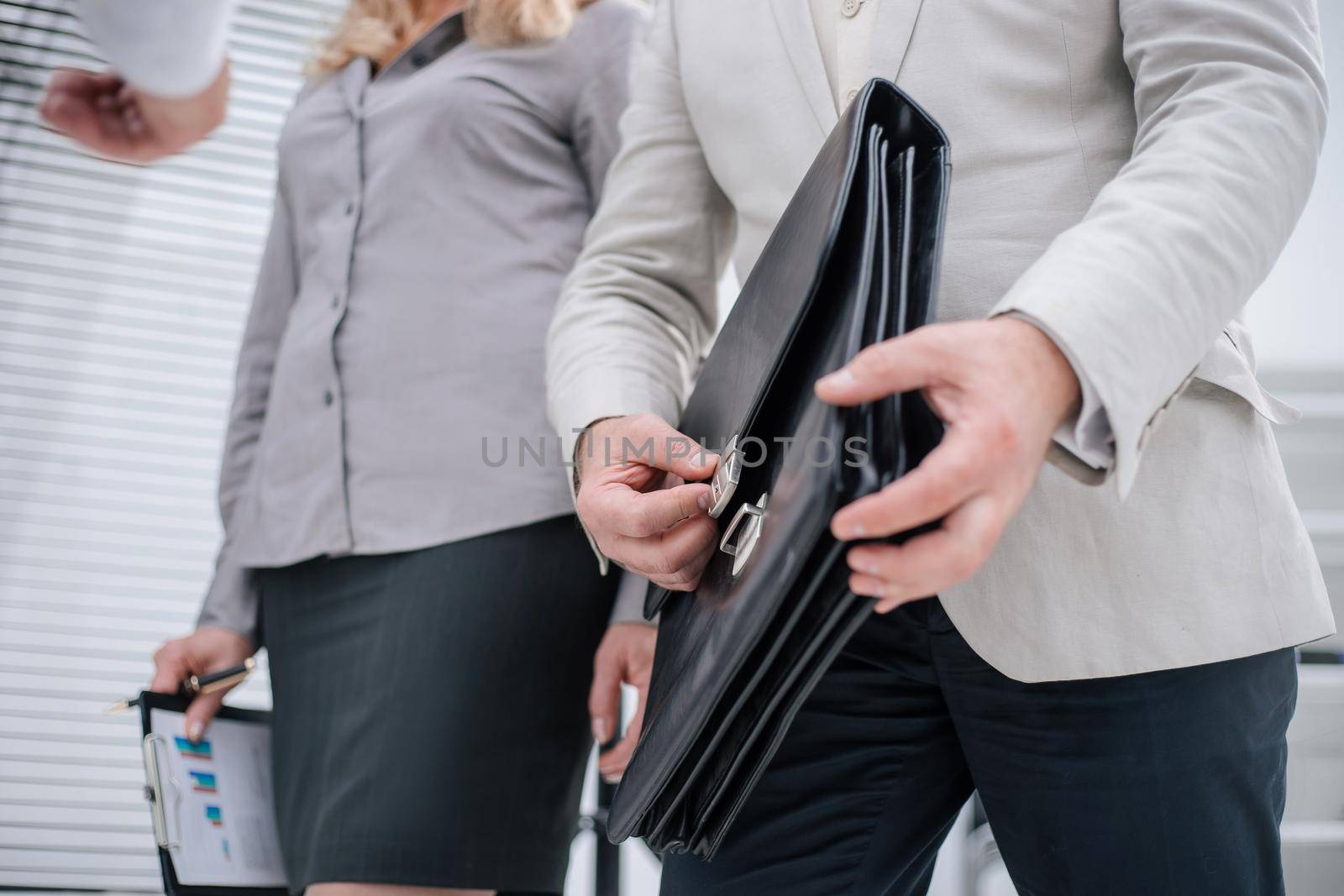 close up. business colleagues passing through the office corridor. business concept