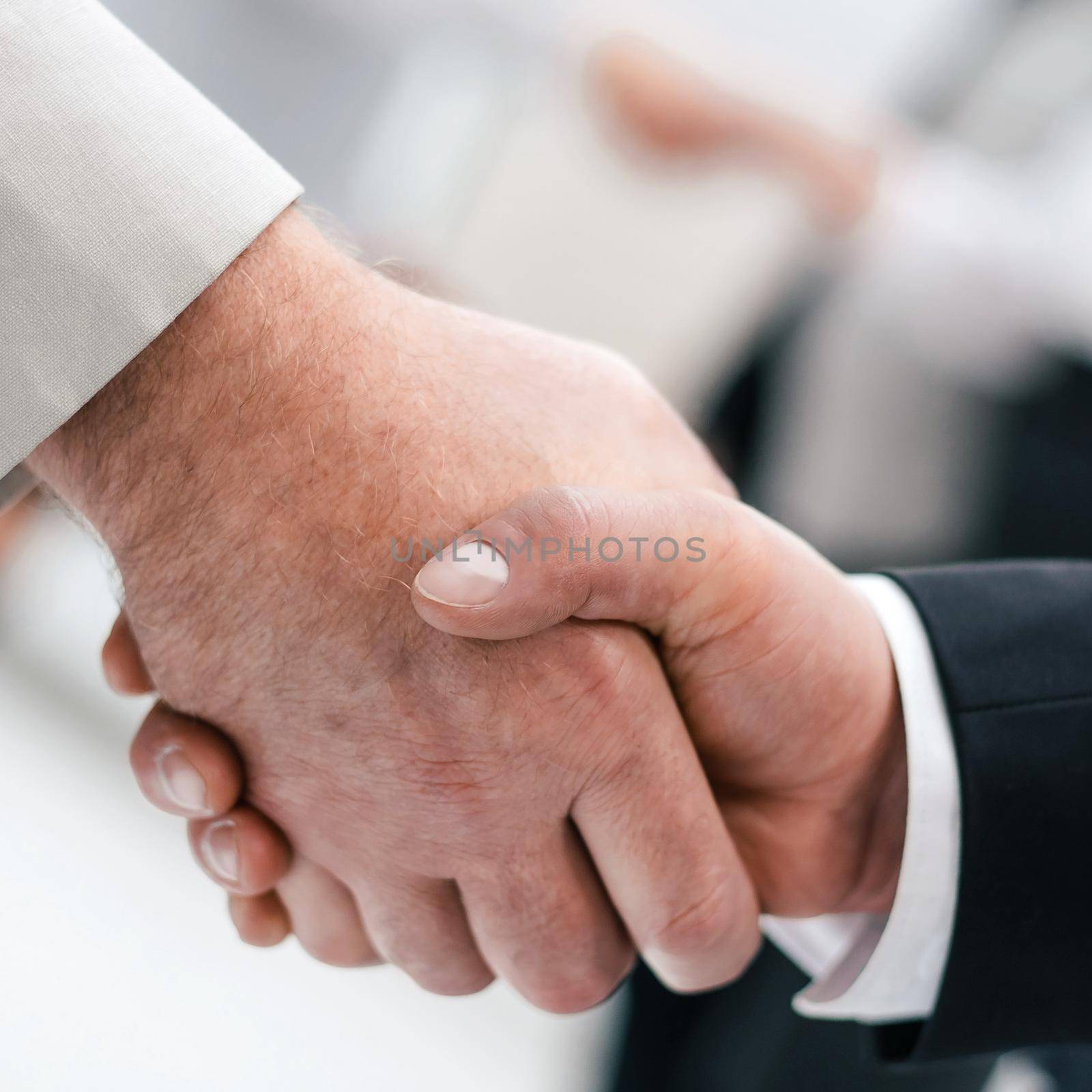 close up.strong handshake of business people in the office. by SmartPhotoLab