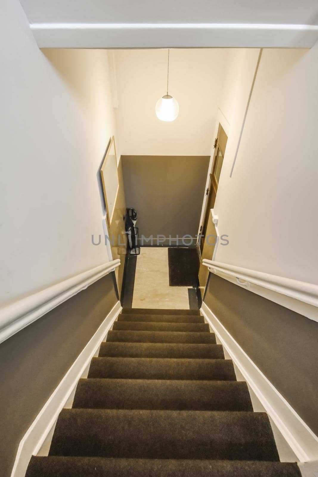 Beautiful staircase with gray carpet and comfortable handrails