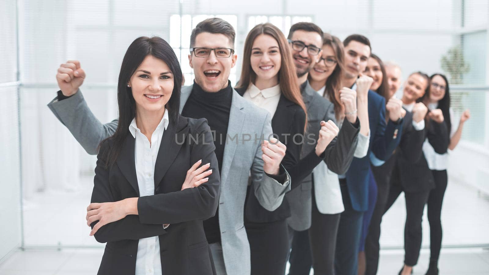 happy group of diverse young people standing in a row by SmartPhotoLab