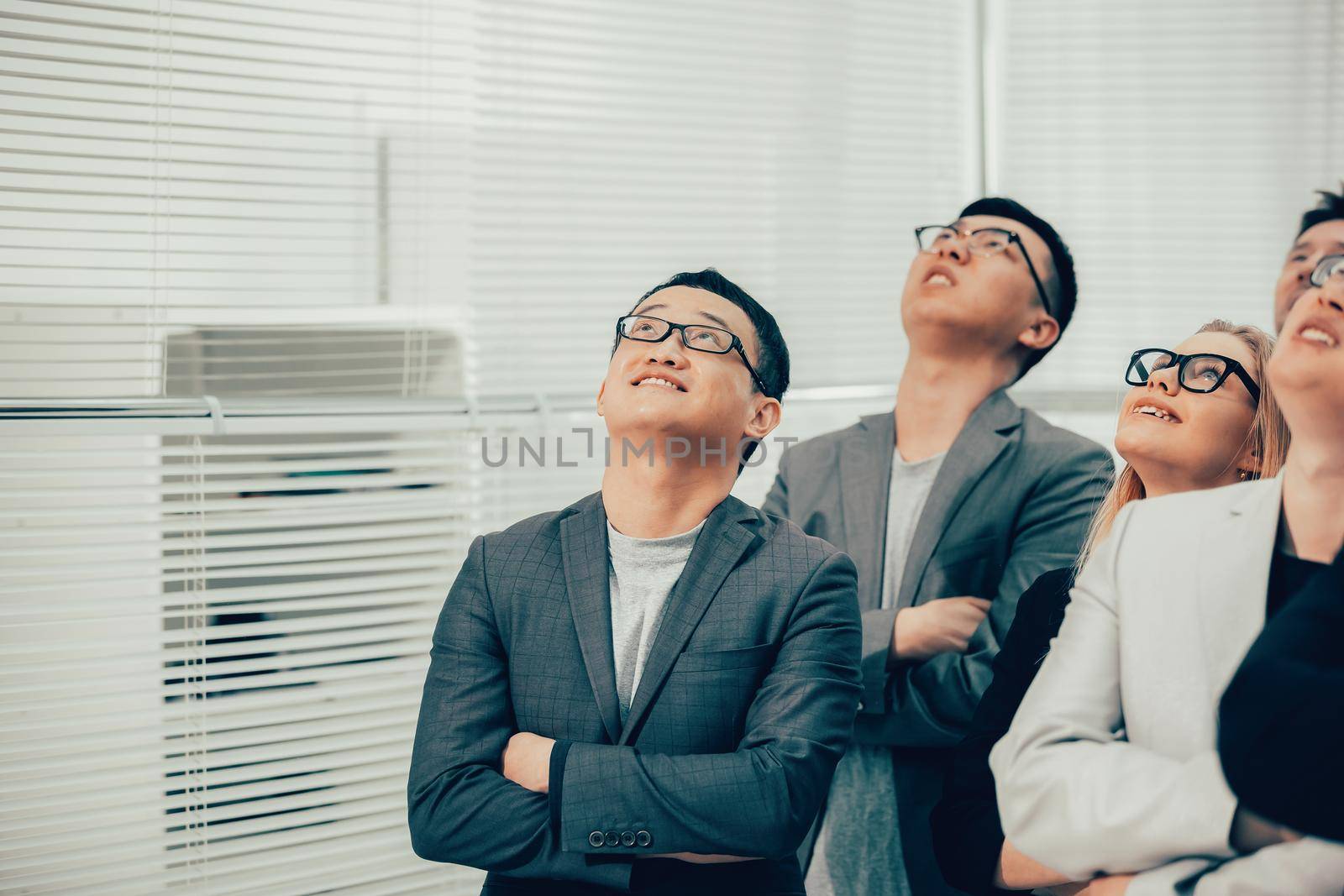 close up. a group of young business people looking up. photo with copy-space