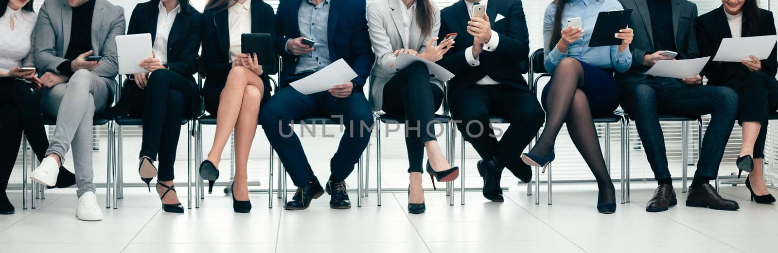 group of employees using their devices in the conference room. photo with a copy of the space