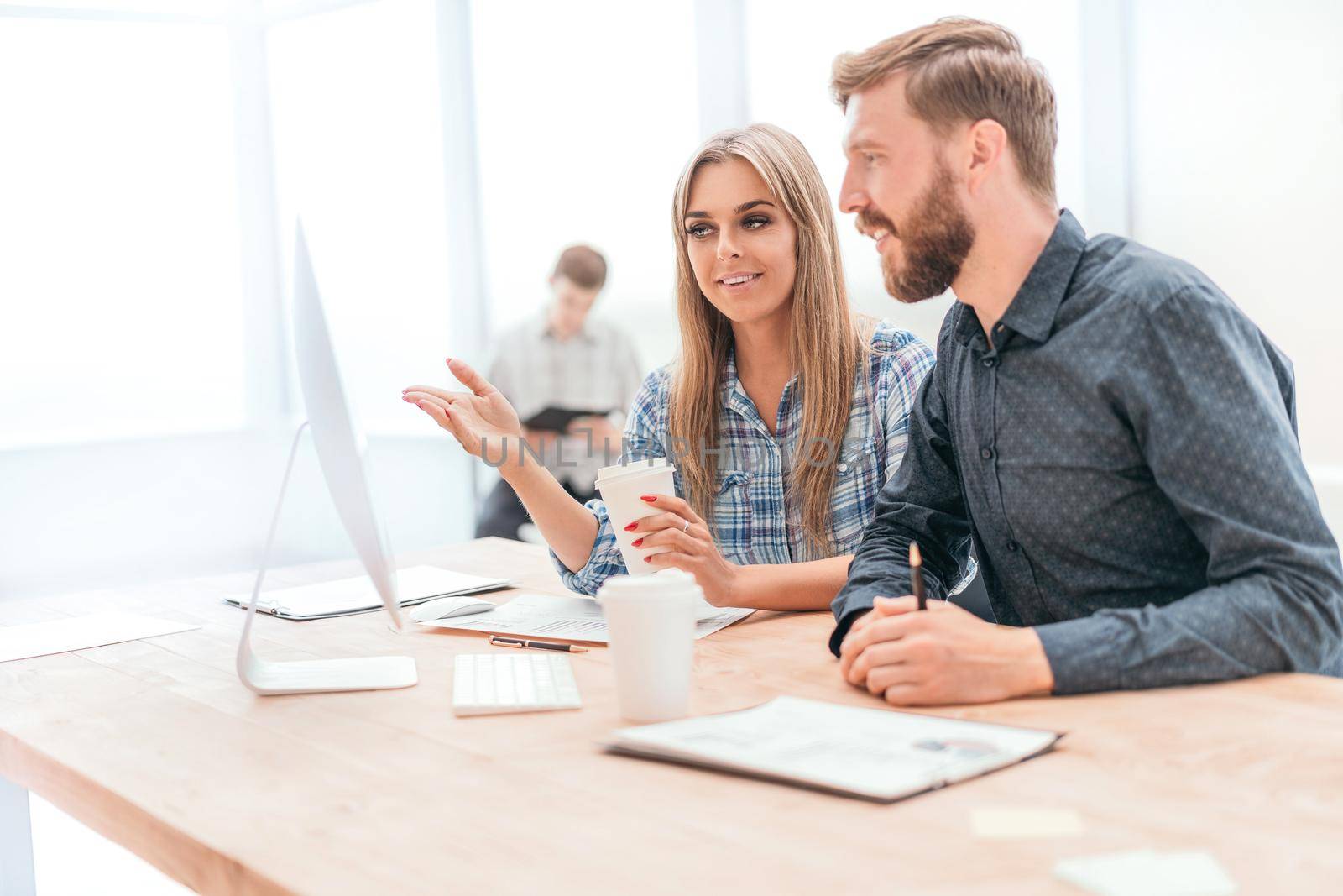 employees discussing online data in the office. office weekdays