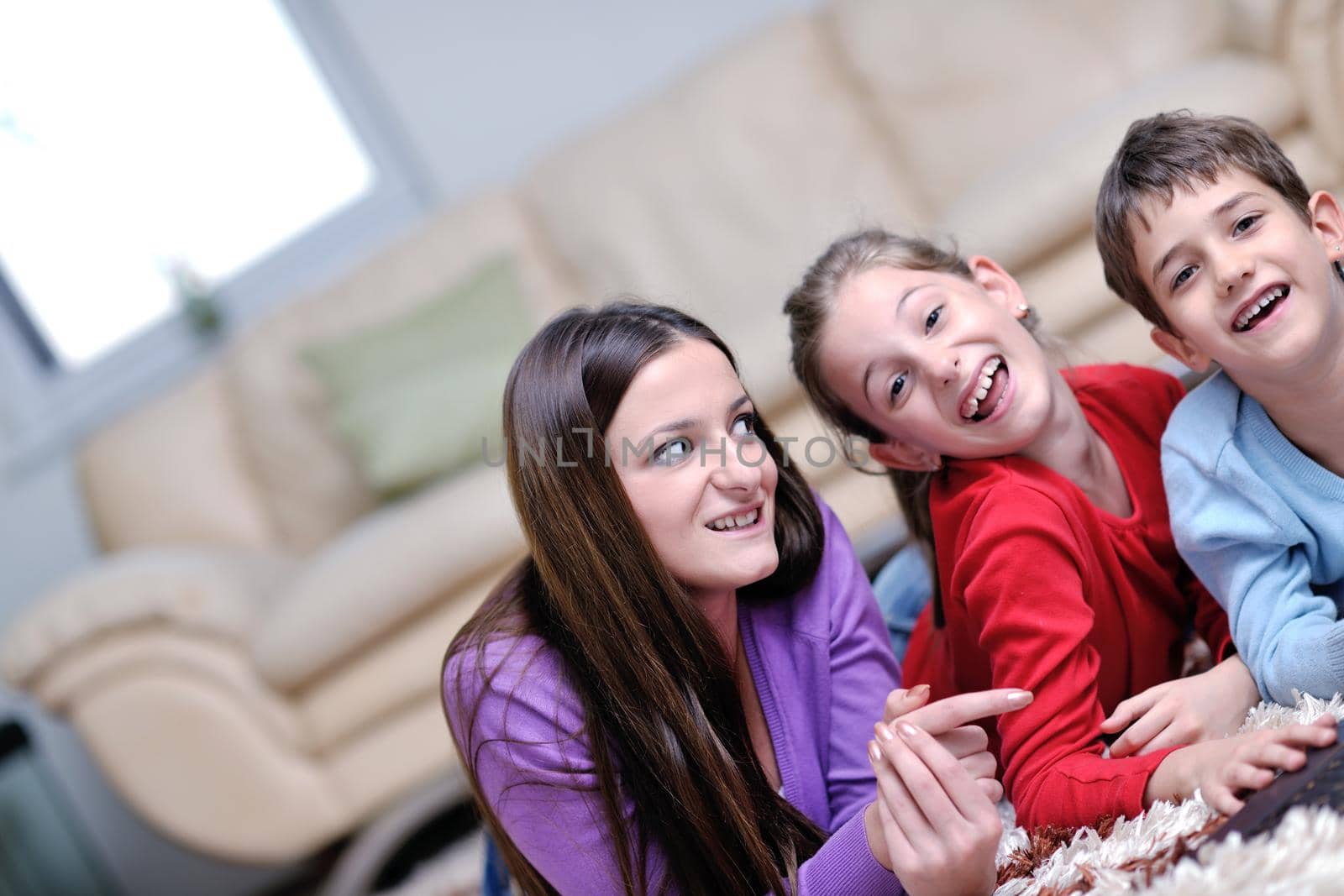 happy young family with mom and kids have fun and play in modern new living room home indoor