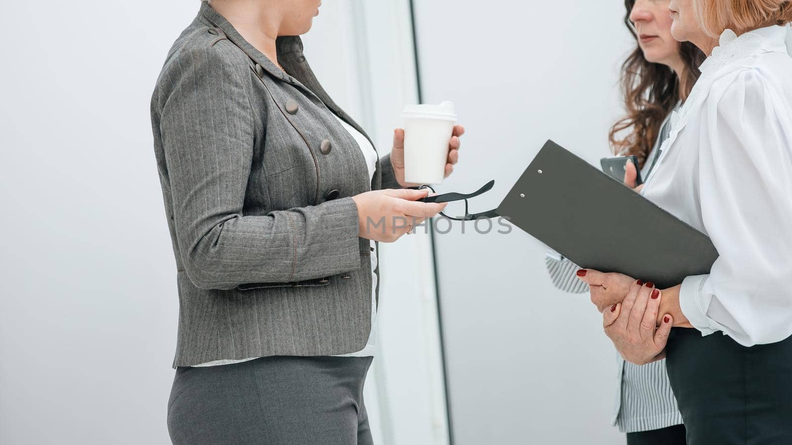close up. businesswoman discussing with employees working issues. office weekdays