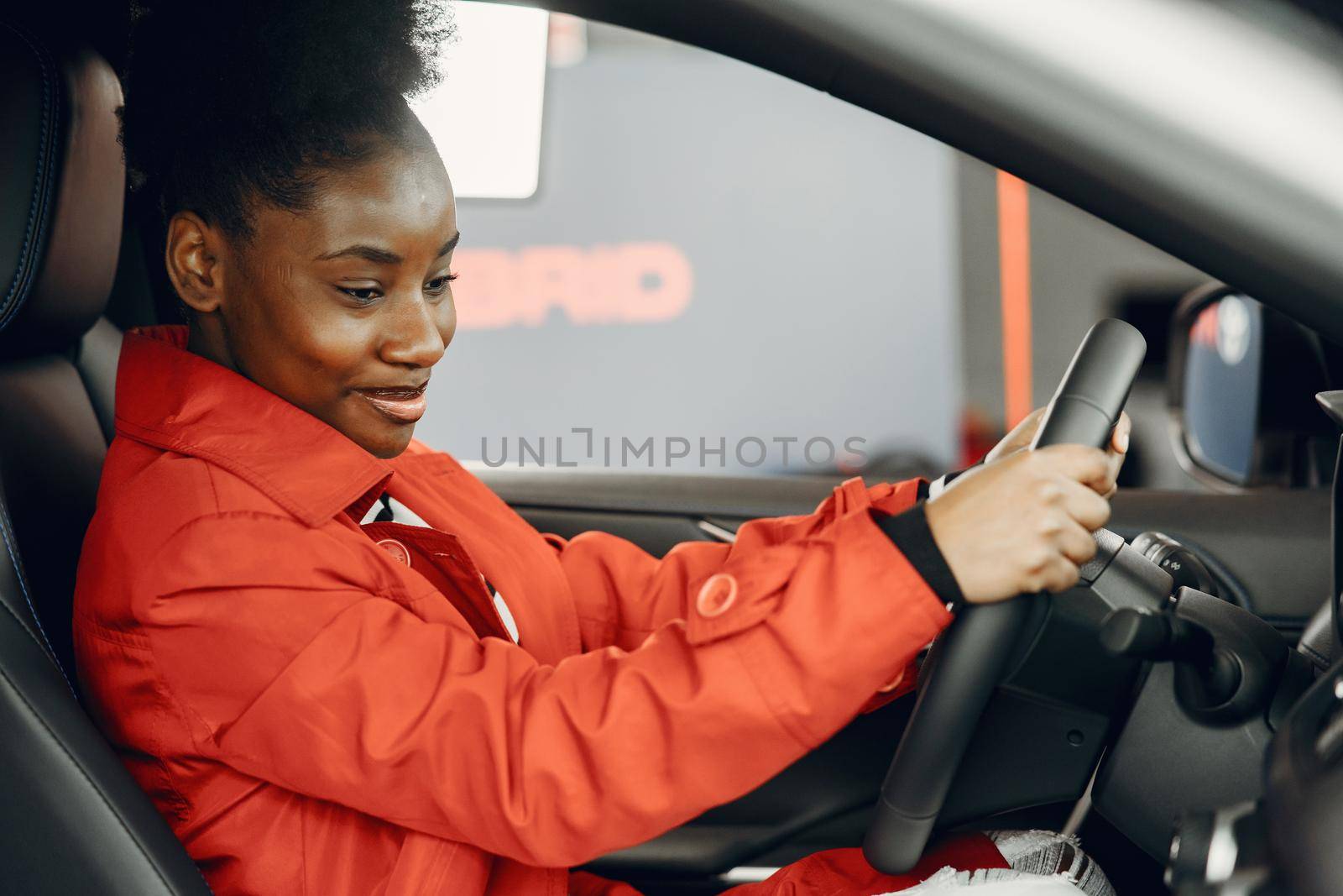 Went shopping today. Shot of an attractive African woman sitting in a car salon.