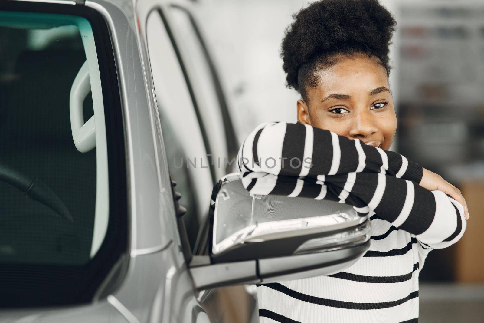 Went shopping today. Shot of an attractive African woman shooses a car.