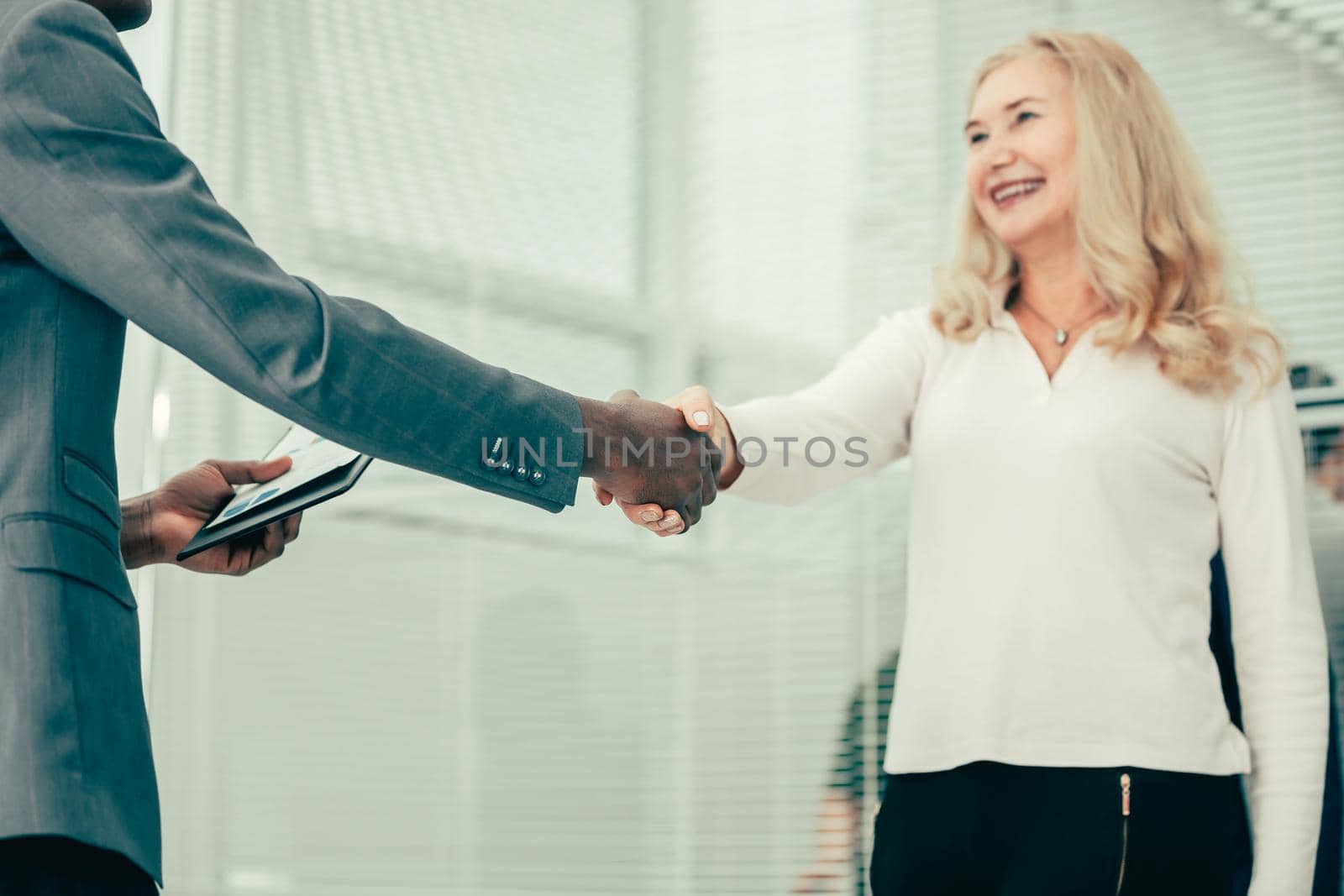 close up. young business woman meeting her business partner with a handshake. the concept of cooperation