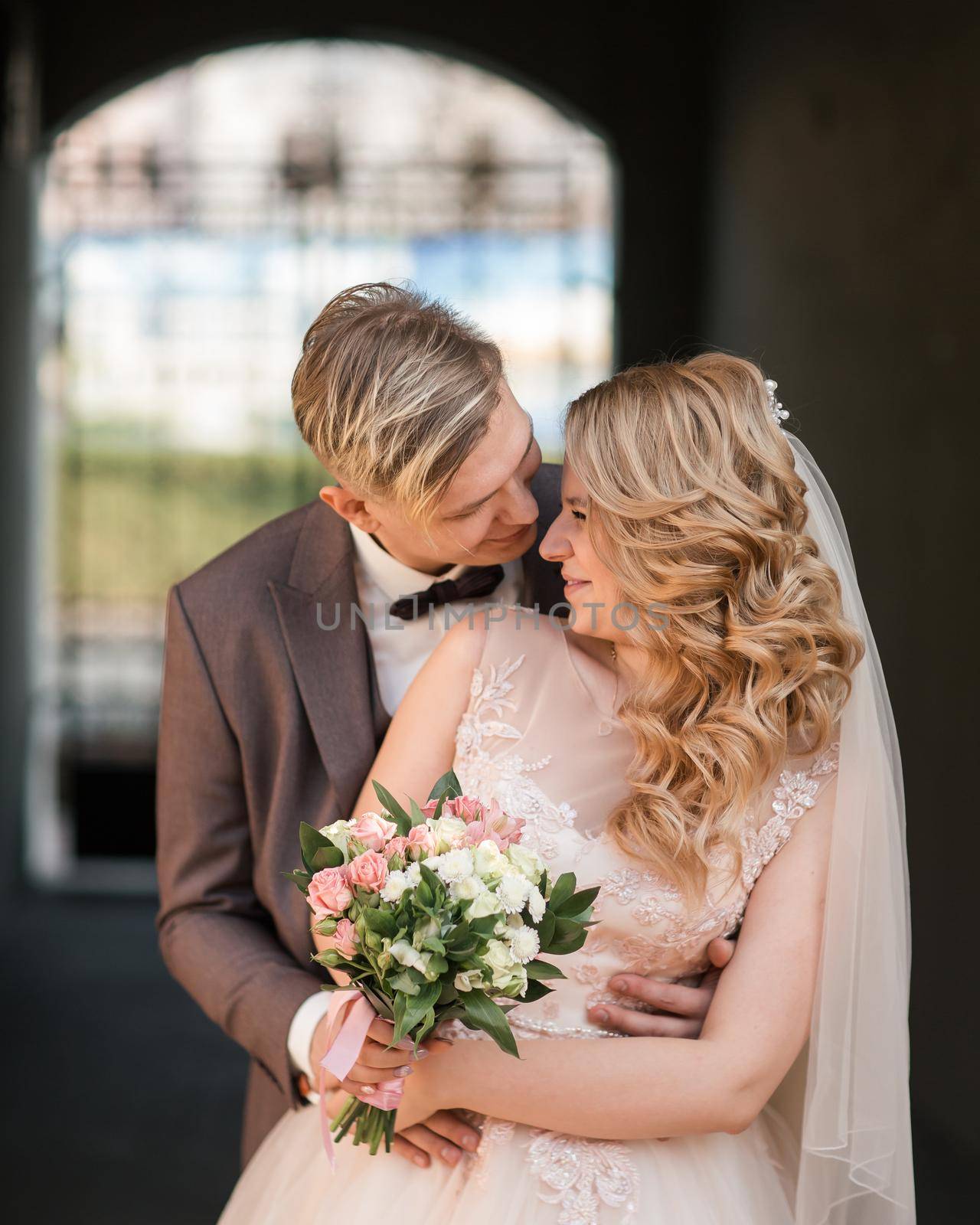 bride and groom look at each other tenderly. holidays and events