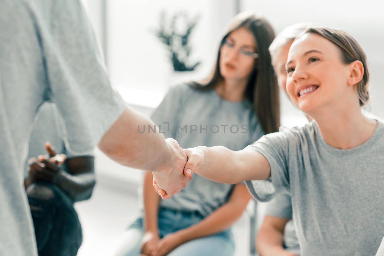 young employees greeting each other with a handshake by SmartPhotoLab