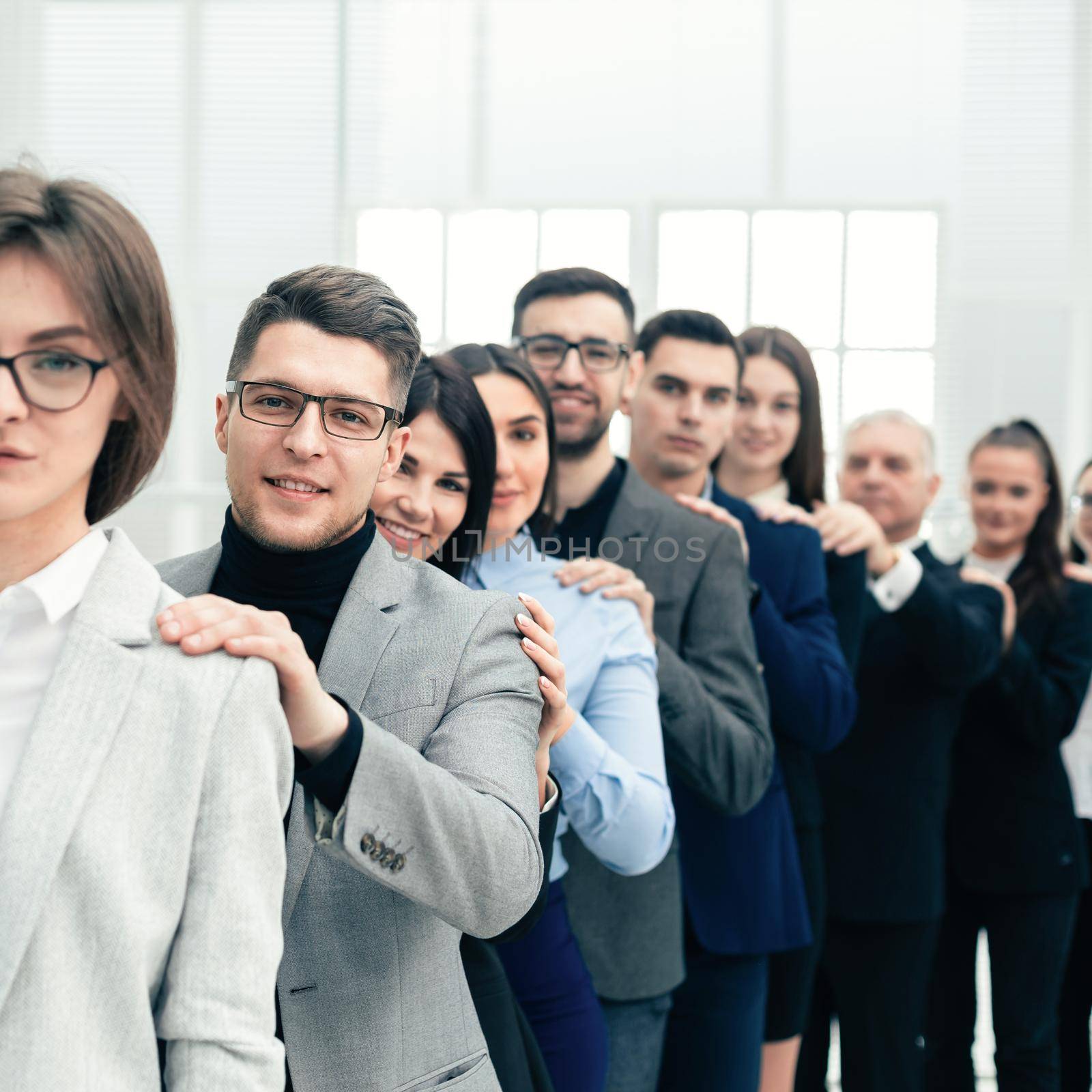 group of young business people standing behind each other by SmartPhotoLab