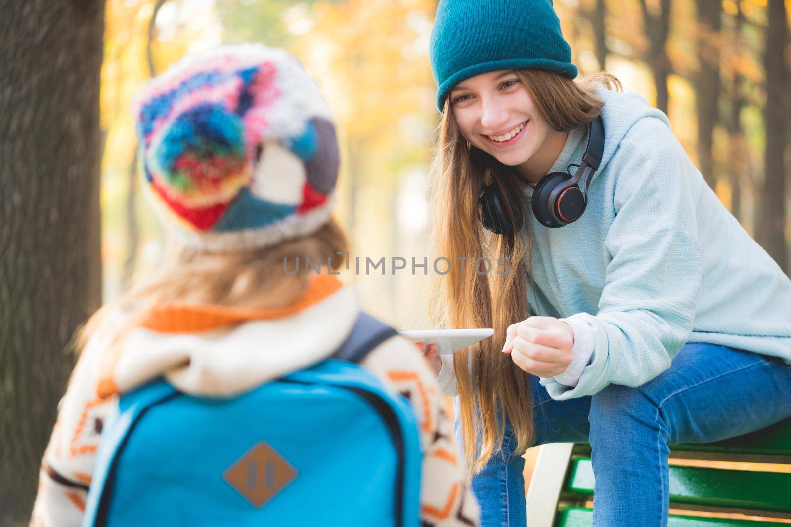 Older sister meets schoolgirl in autumn park