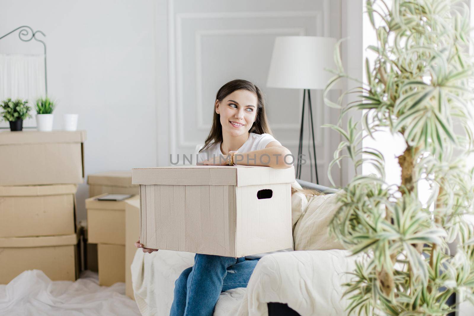 close up. a cardboard box with personal items in the hands of a young woman