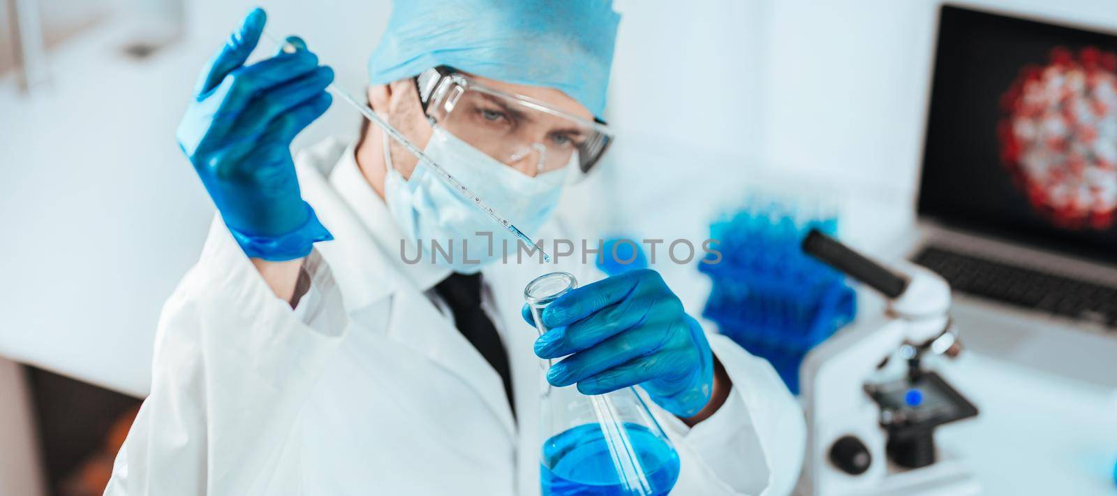close up. scientist studying the liquid in a medical flask. photo with a copy-space.