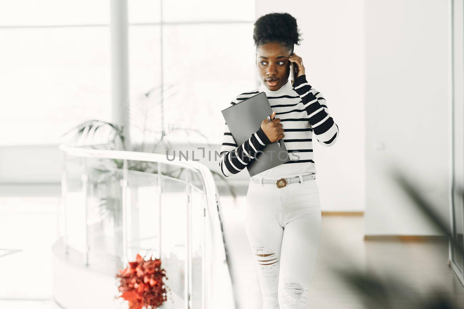 Woman with mobile phone. Lady with documents.