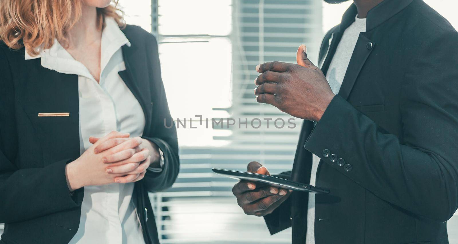 close up. young business colleagues are talking standing in the office. office workdays