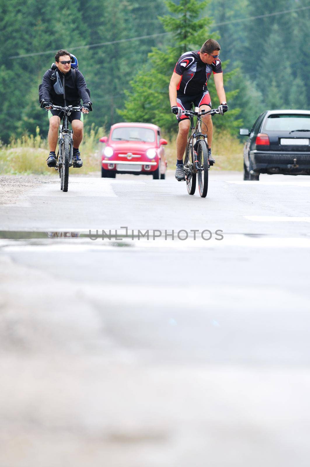 two friends have fun outdoor in nature and representing concept of  healthy life and fitnes on muntain bike 