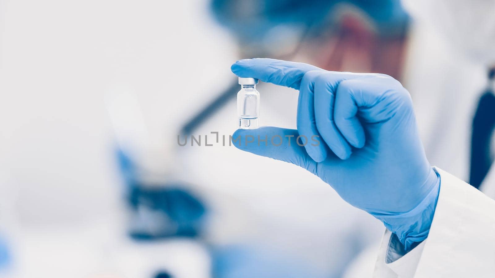 close up. vial with a vaccine in the hands of a scientist. photo with a copy-space.