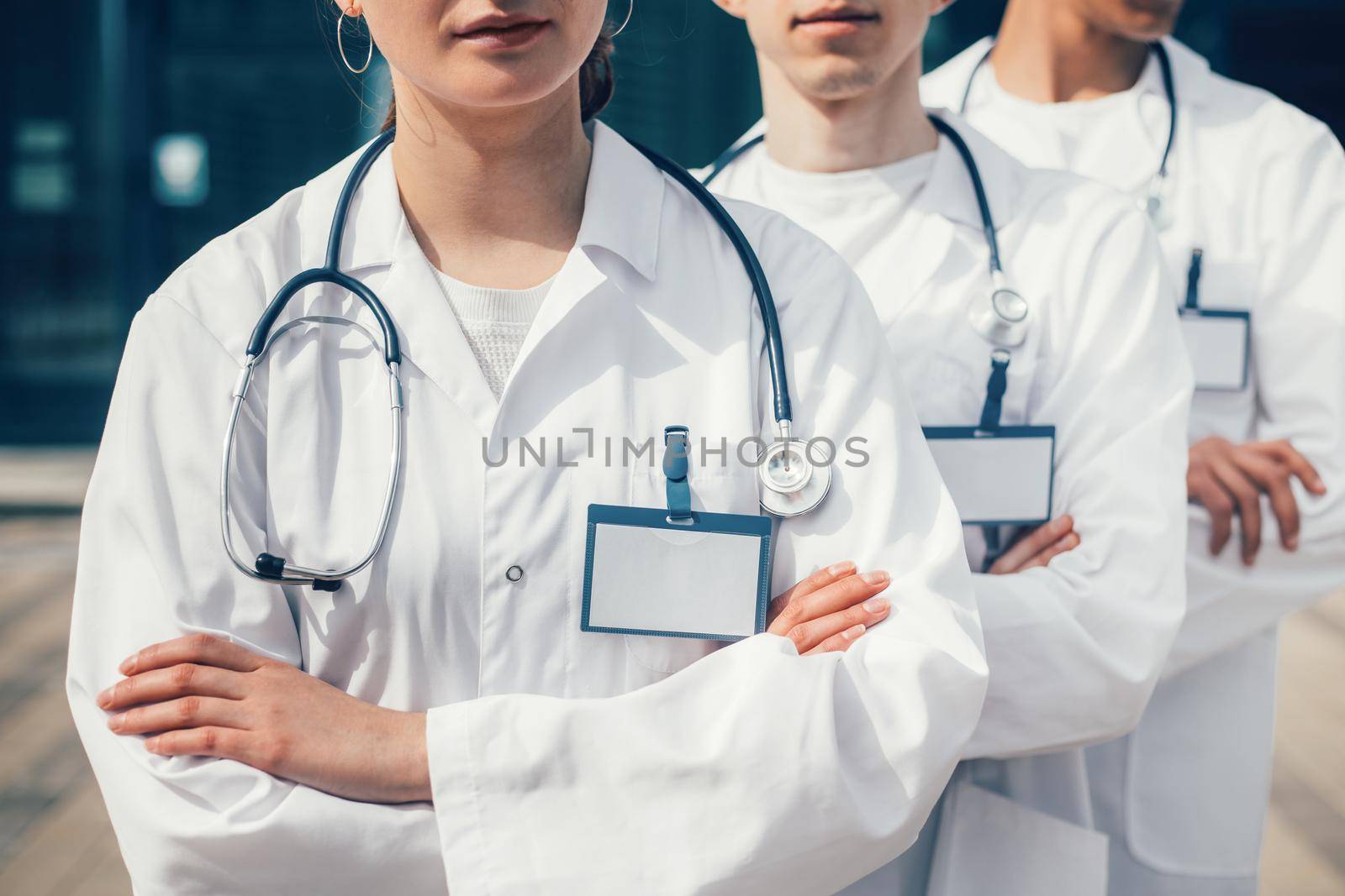 close up. group of medics with blank badges standing in a row. photo with a copy-space.