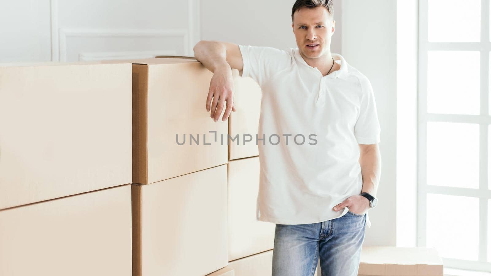 confident young man standing in his new apartment. photo with copy-space