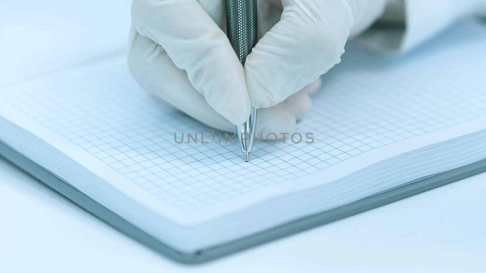 close up. scientist making notes in his notebook . photo with a copy-space.