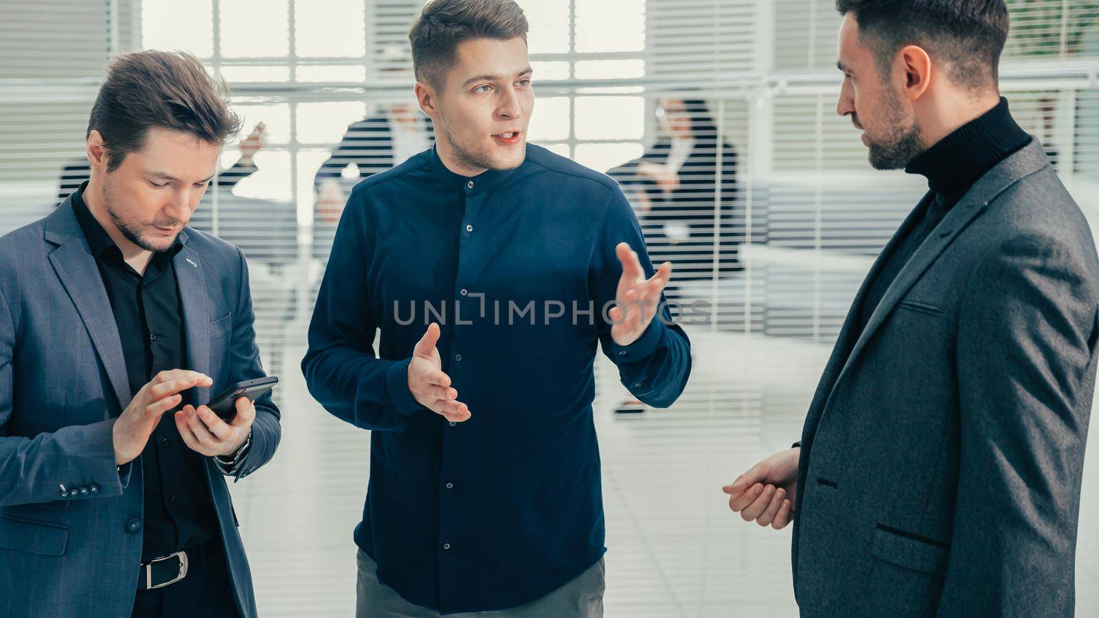 group of employees talking standing in the office. business concept.