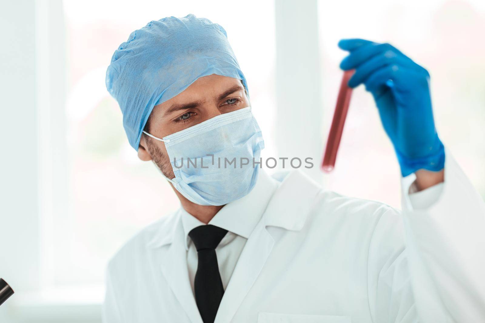close up. test tube in the hands of the scientist. the concept of health.