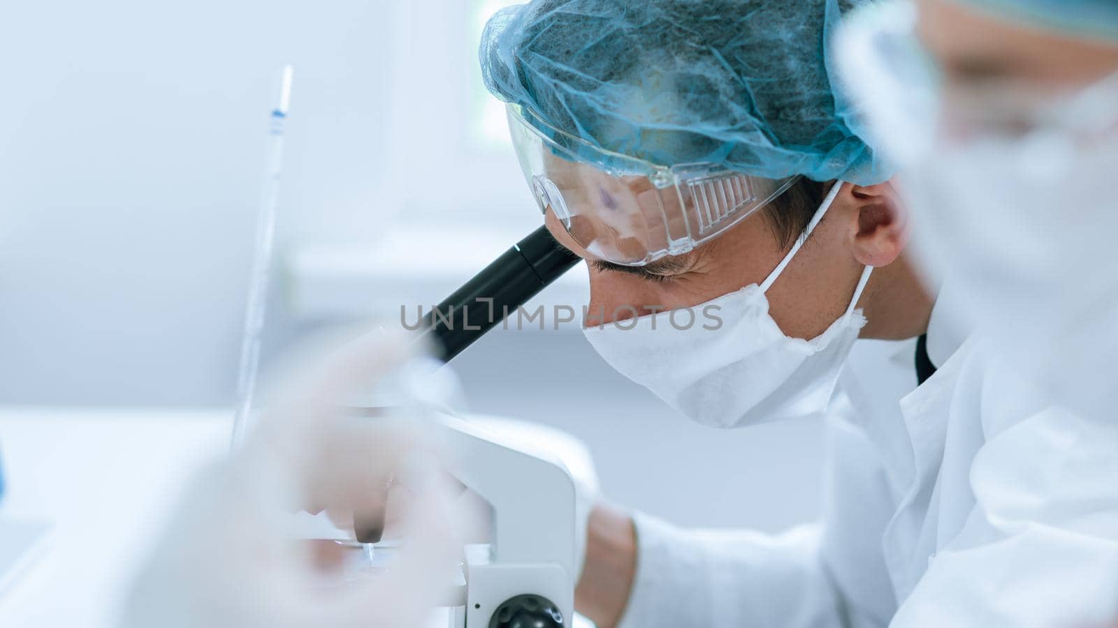 close up. ampoule with a new vaccine in the hands of a scientist. photo with a copy-space.