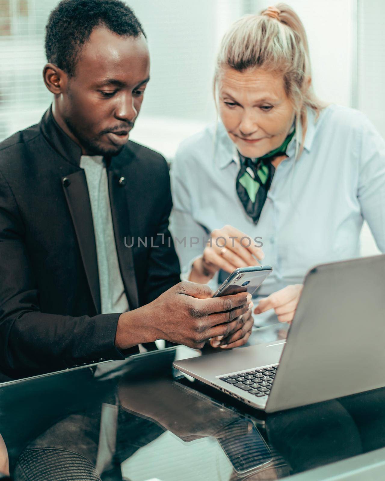 close up. business colleagues discussing online news in the workplace.