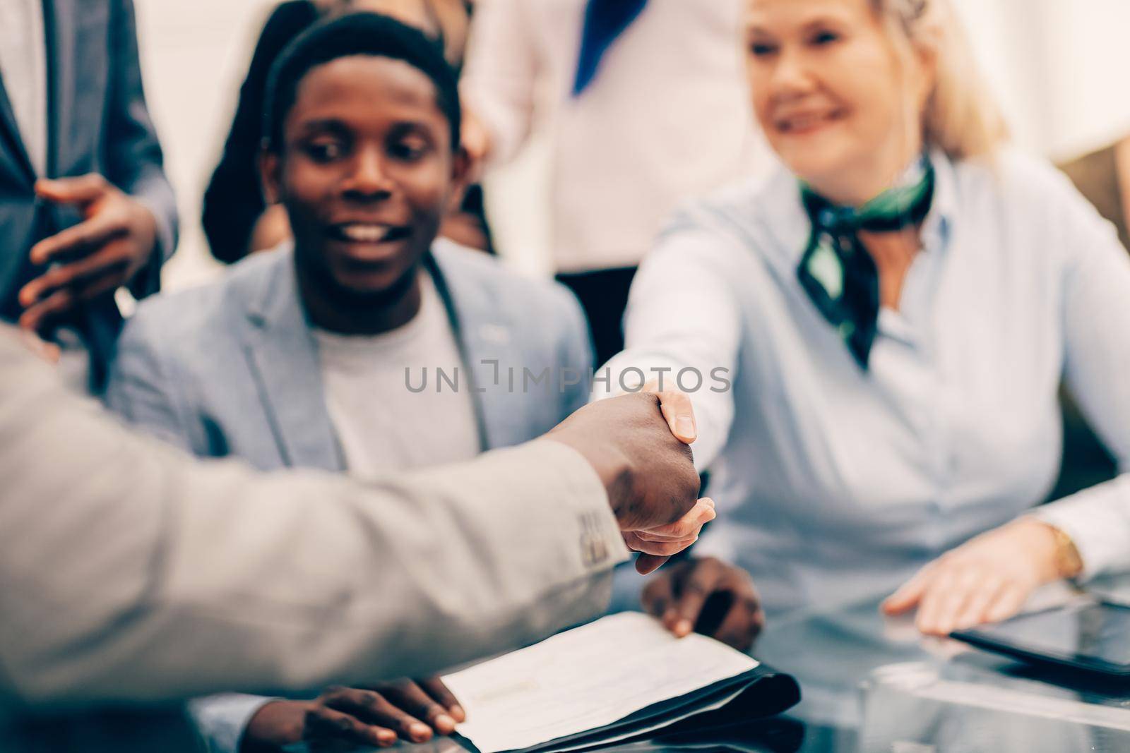 close up. smiling international business partners shaking hands. the concept of cooperation