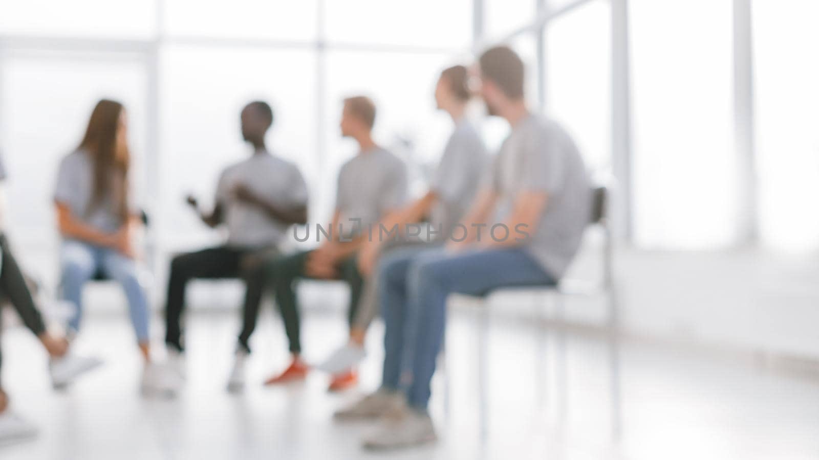 background image of a group of young people at a meeting in a c by SmartPhotoLab