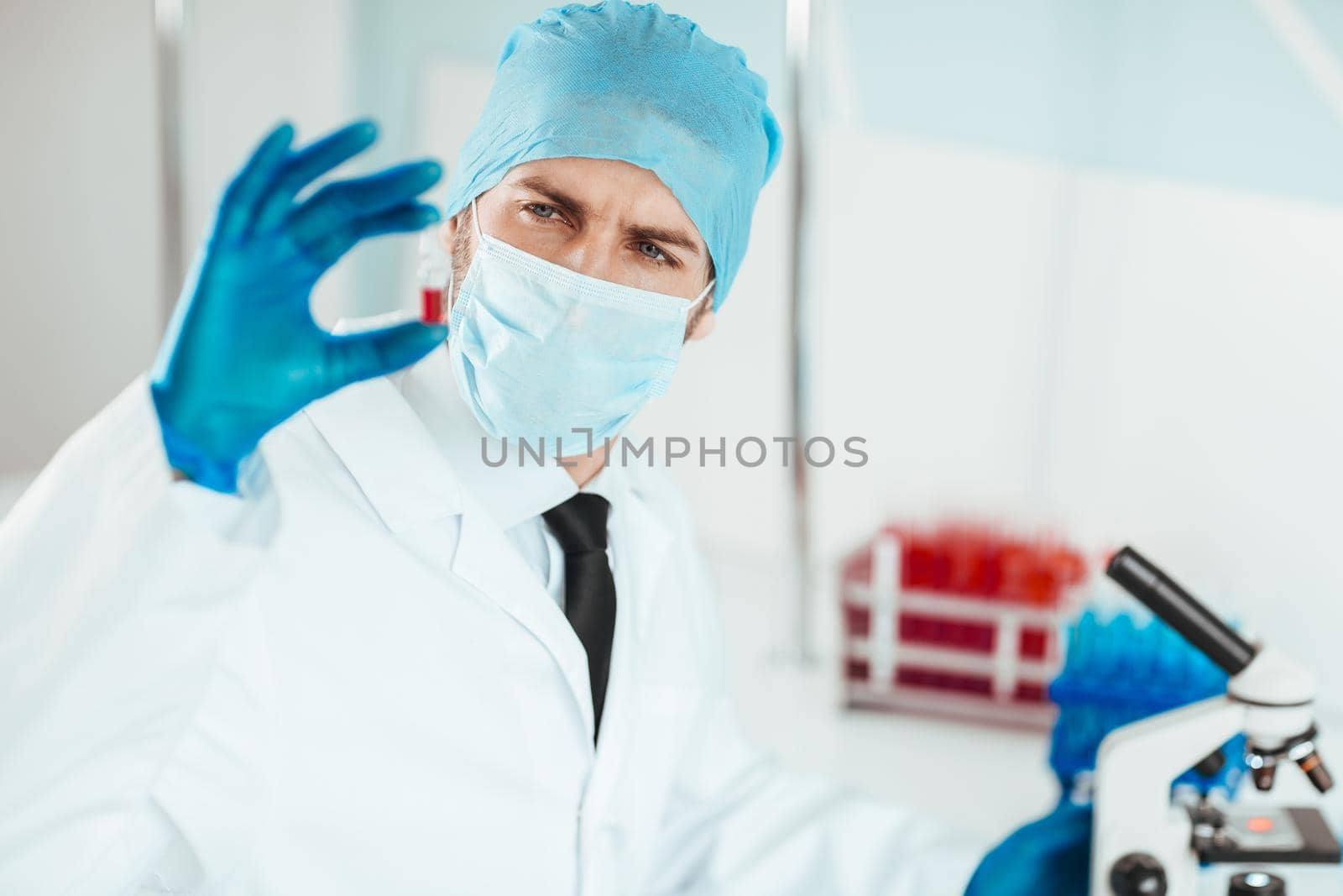 close up. ampoule with a vaccine in the hands of a scientist. health concept.