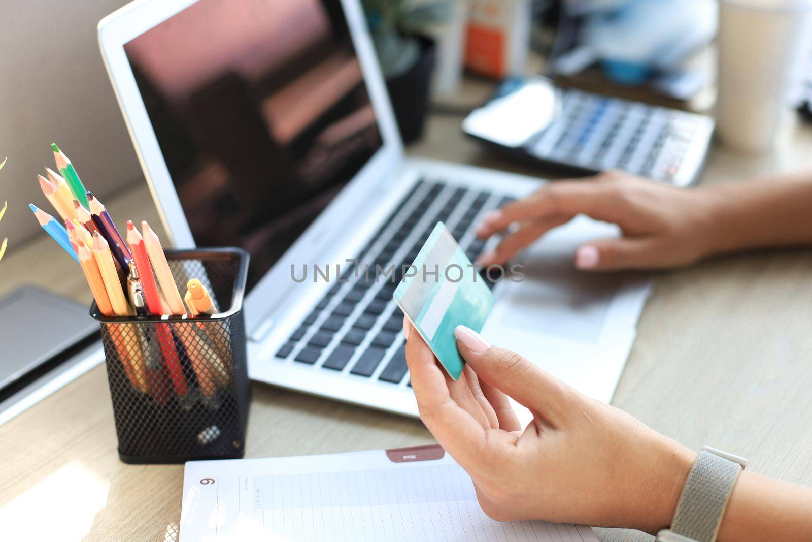 Woman holding credit card on laptop for online shopping concept. by tsyhun
