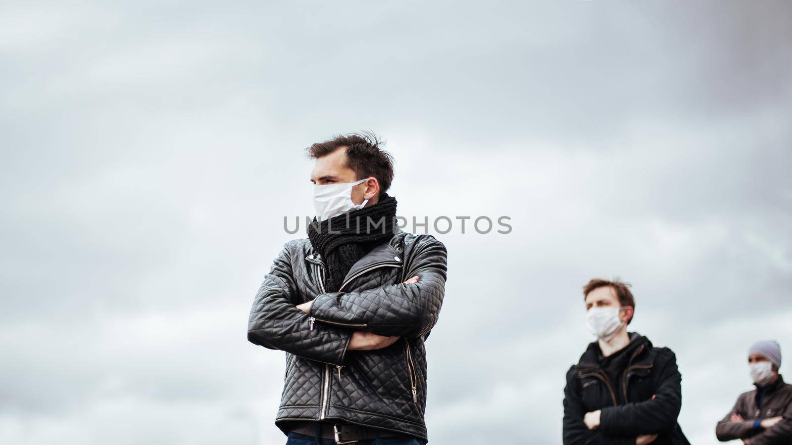 people in protective masks standing at a safe distance. concept of health protection