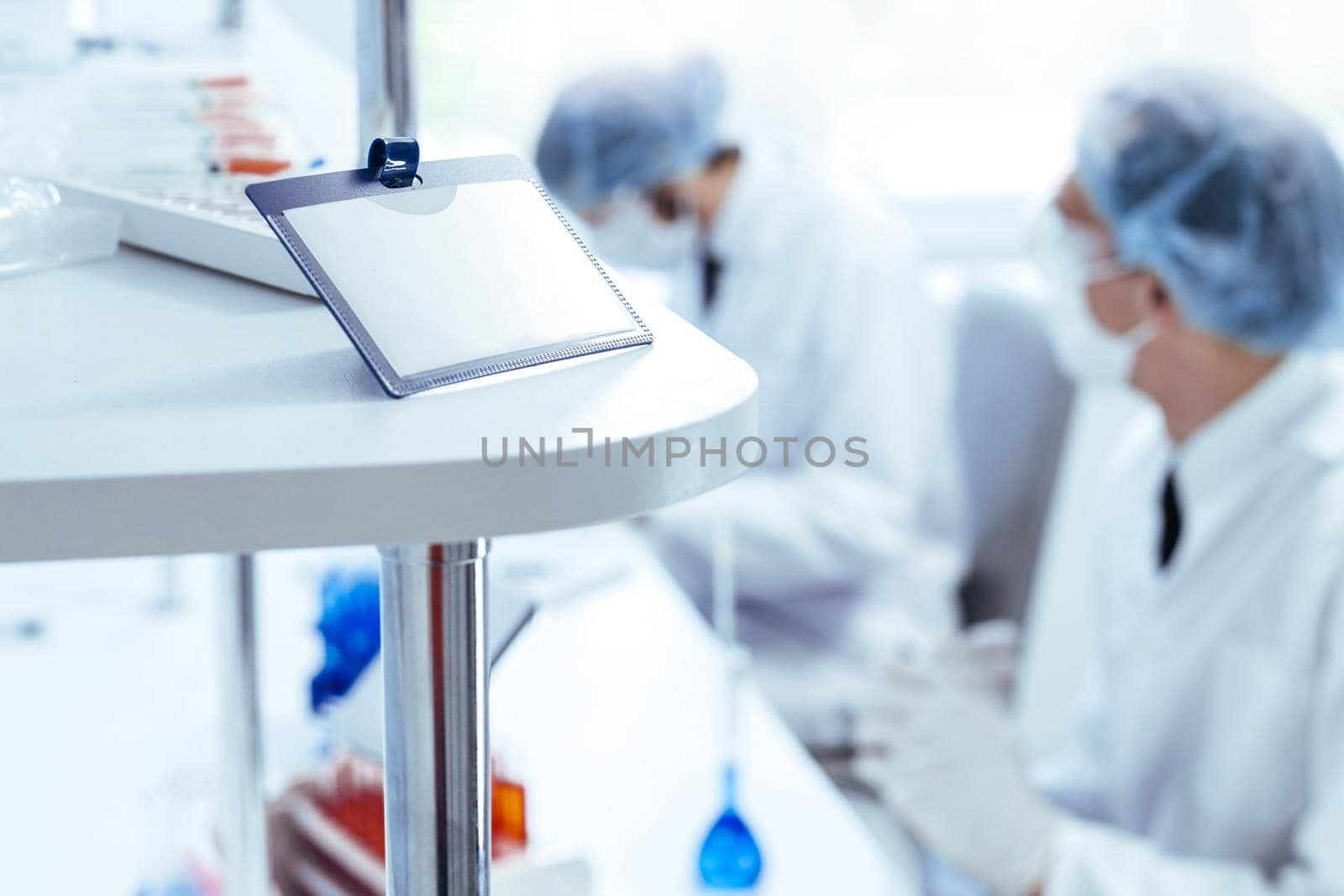 close up. blank badge on the table in the science lab. photo with a copy-space.