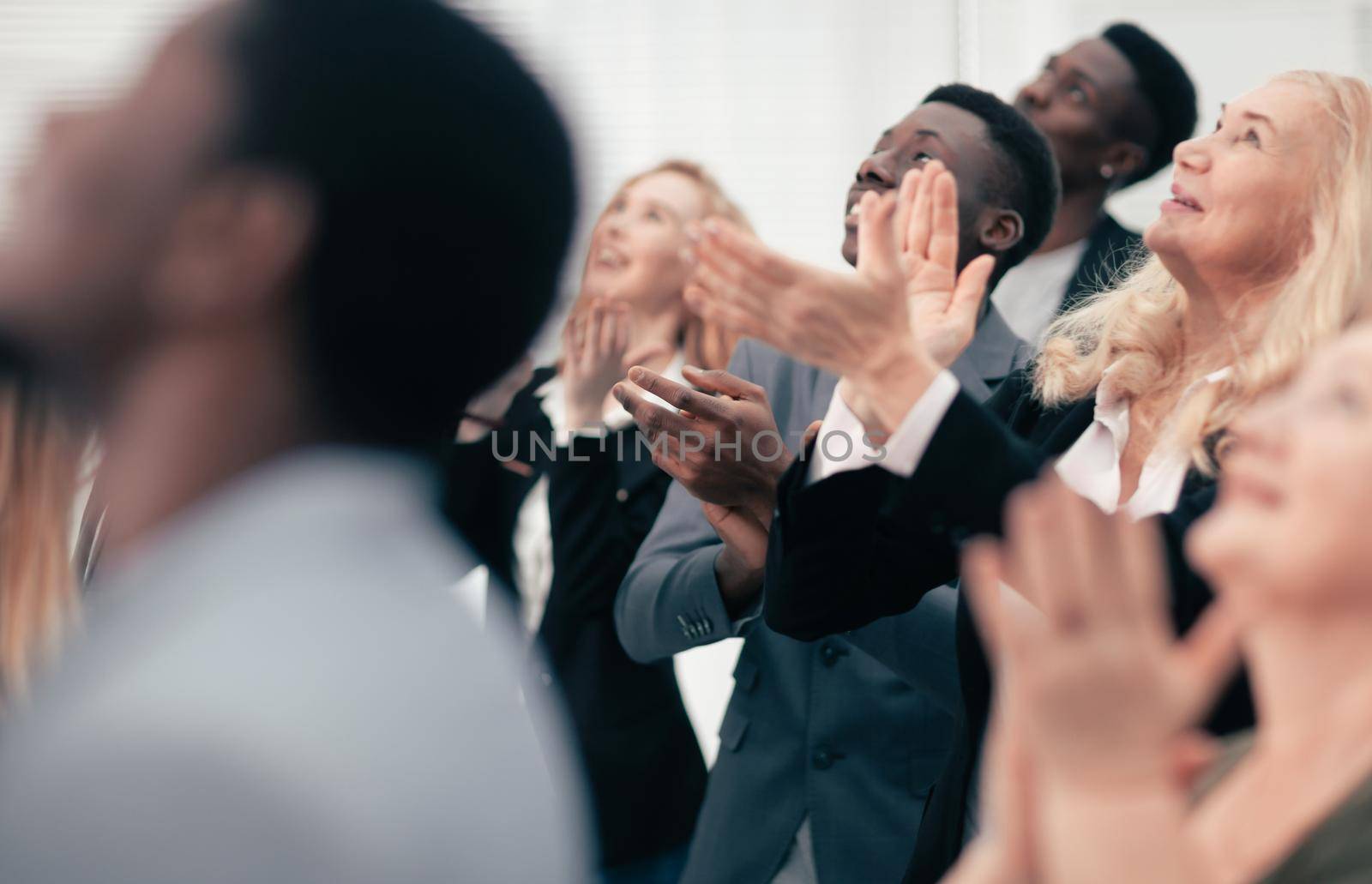 close up. participants of the international business seminar give a standing ovation . success concept