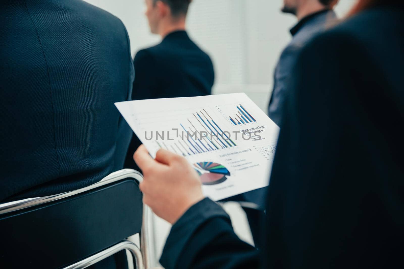 close up. employee with financial of charts while sitting at an office meeting . business concept.