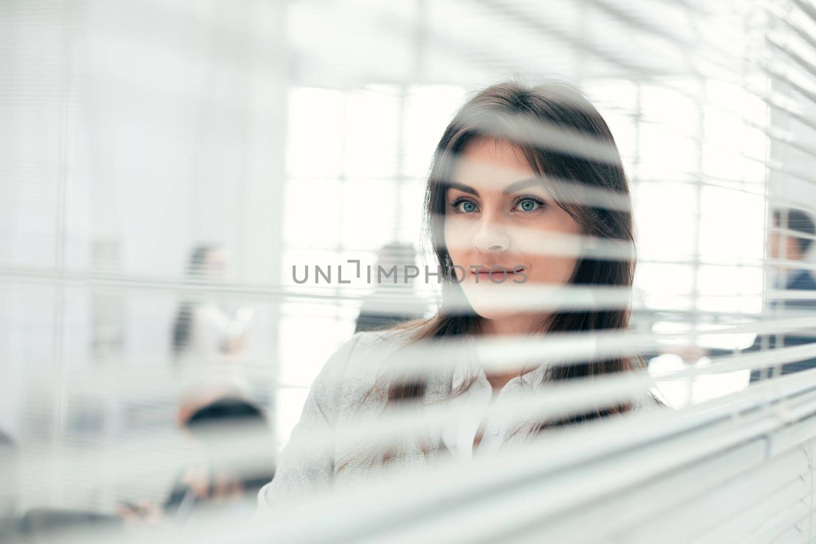 young business woman standing near office window. photo with copy-space