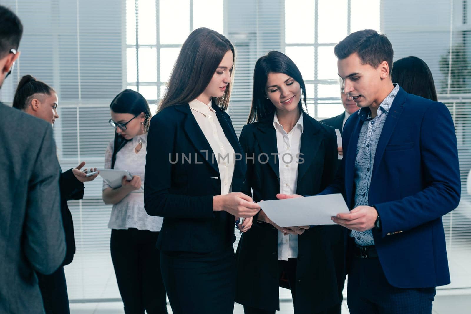 group of young employees discuss a business document. office workdays