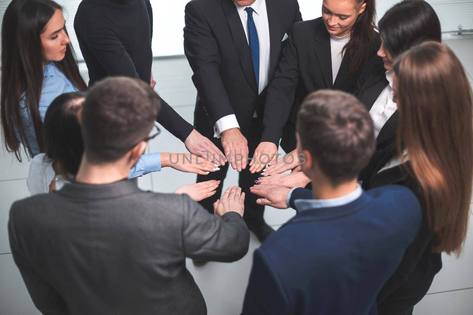 close up. group of young employees standing in a circle . the concept of teamwork