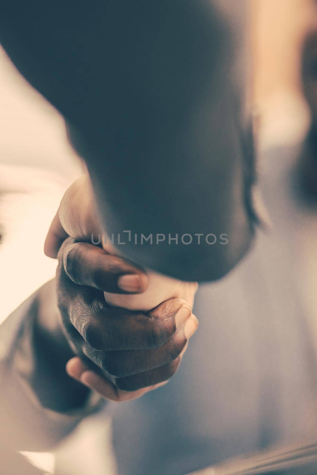 close up. image of a handshake of young business people by SmartPhotoLab