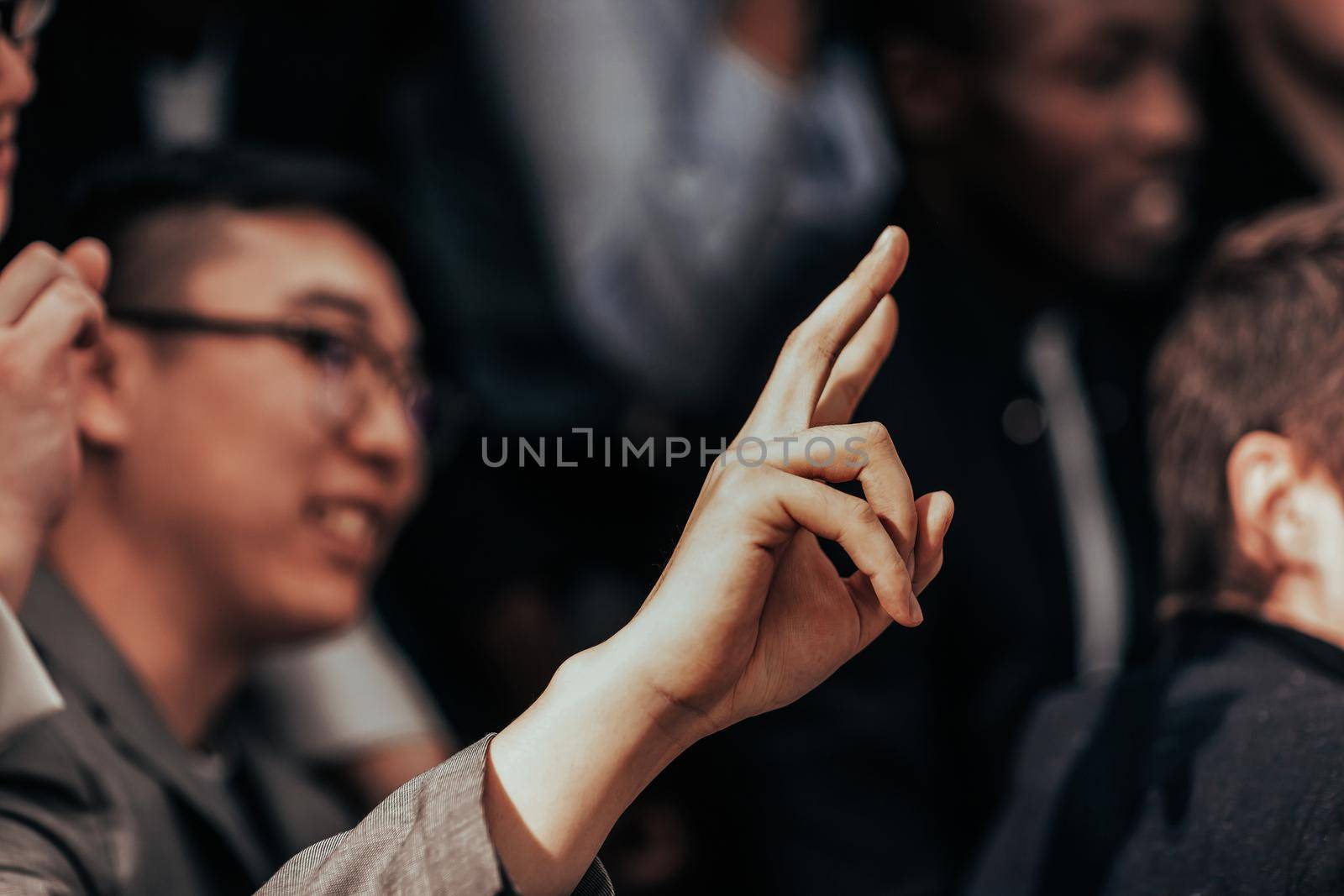 close up. young entrepreneur asking a question to a speaker by SmartPhotoLab