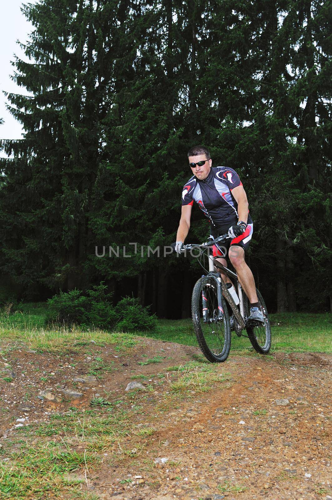 healthy lifestyle and fitness concept with mount bike man who ride bike  outdoor