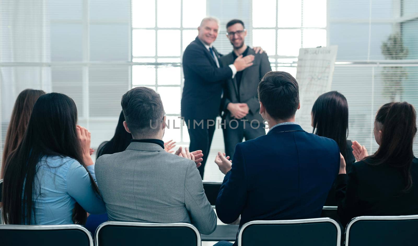 business partners standing together in a conference room during a business meeting.