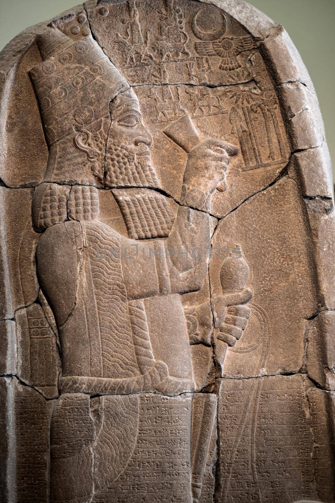 Babylonian bas relief in Berlin Pergamon museum in Germany. Historical ancient art of east religion and civilization made on stone wall. Antique islamic decoration with man